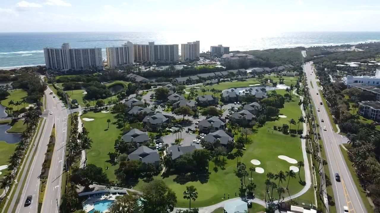 Coastal community aerial view with shingle roofs in Jupiter FL