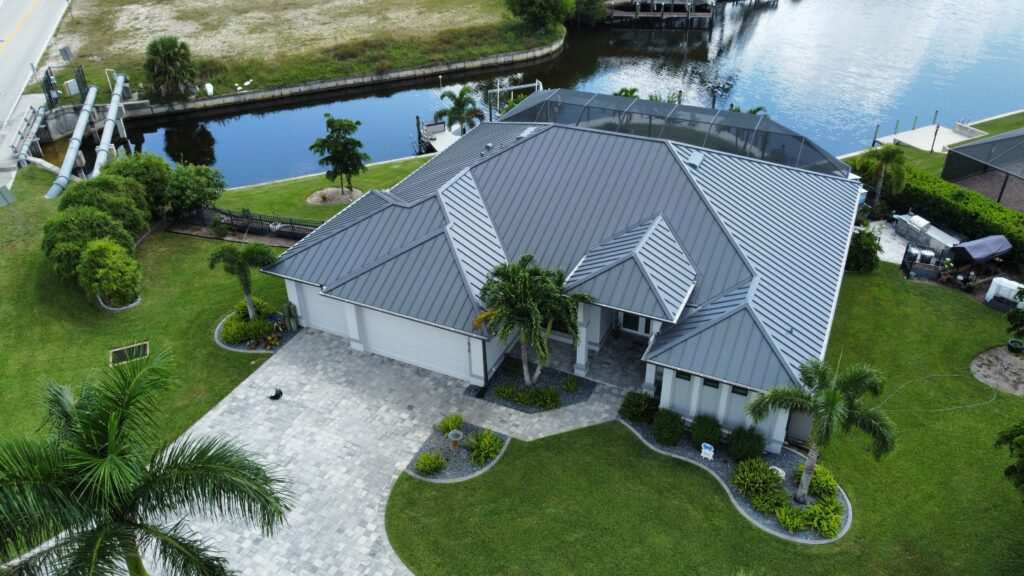 Gray metal roof waterfront home with boat dock