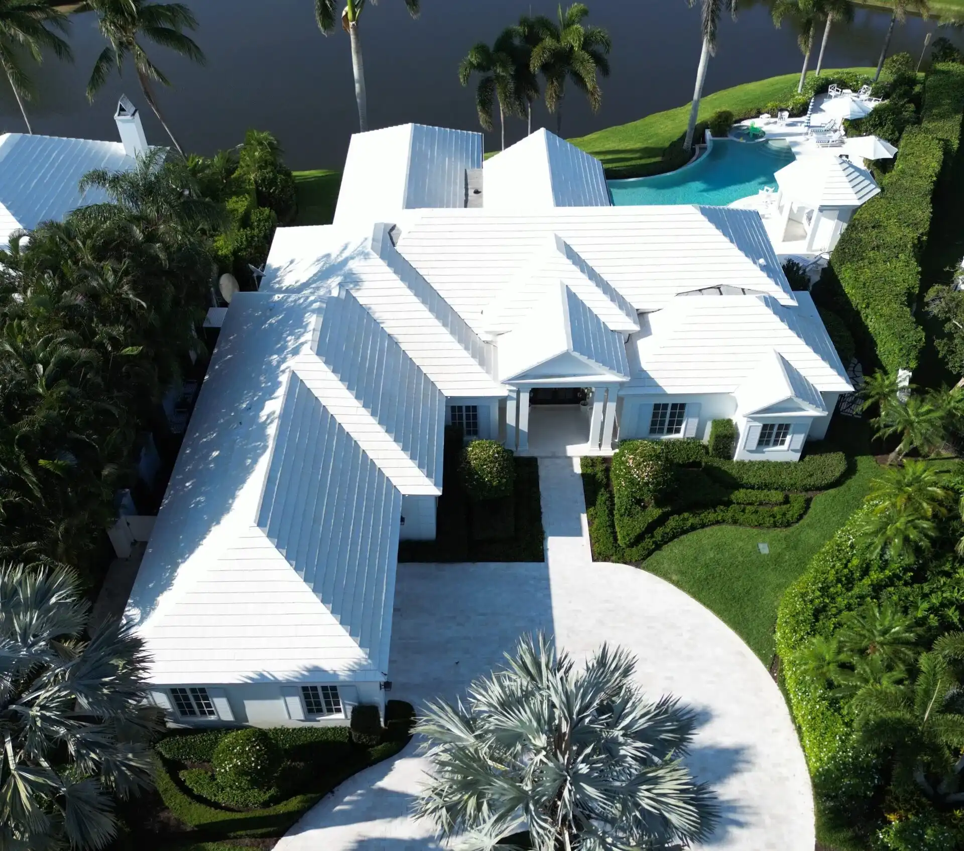 White metal roof waterfront estate with pool