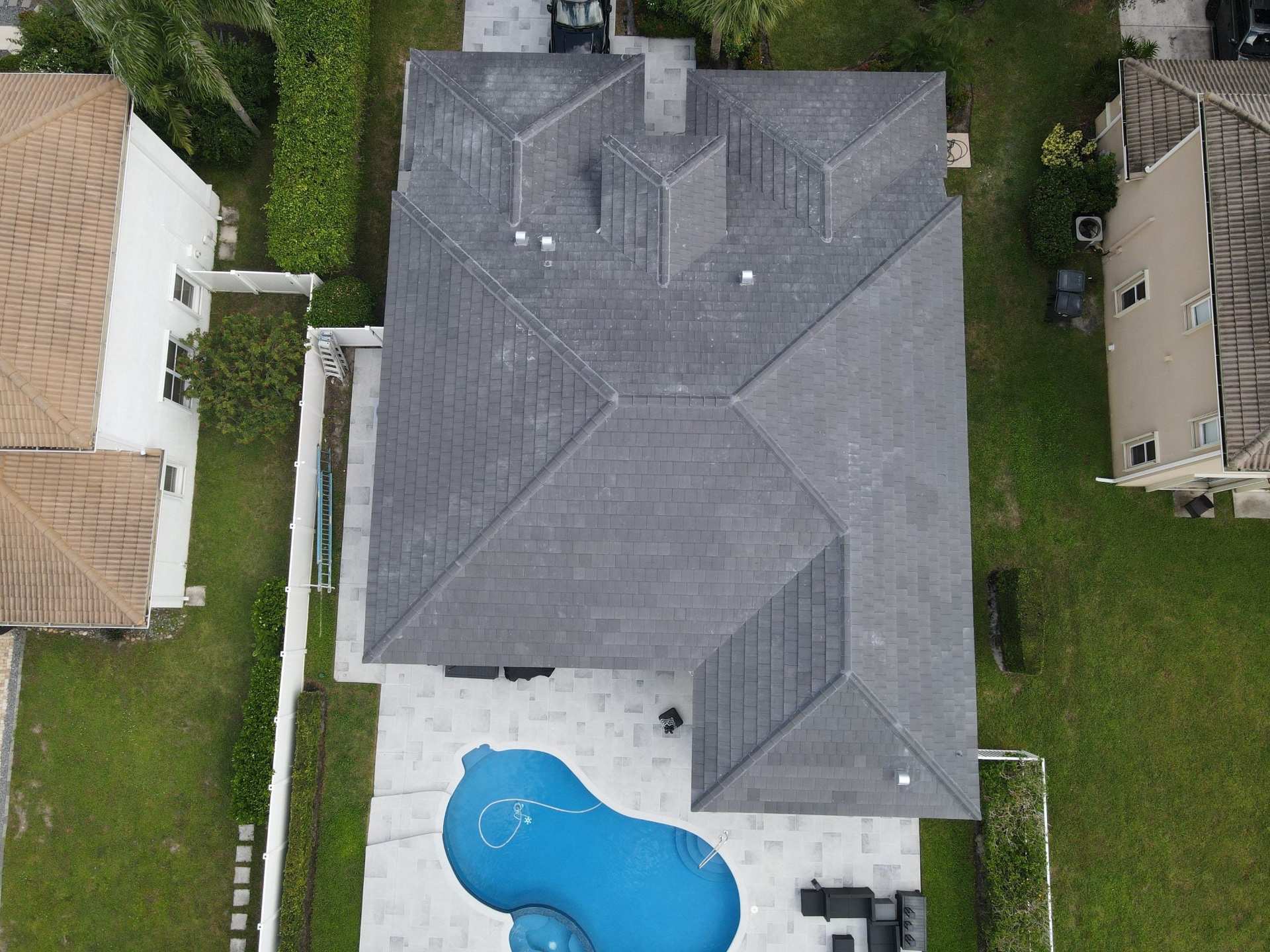 Dark shingle roof home aerial view