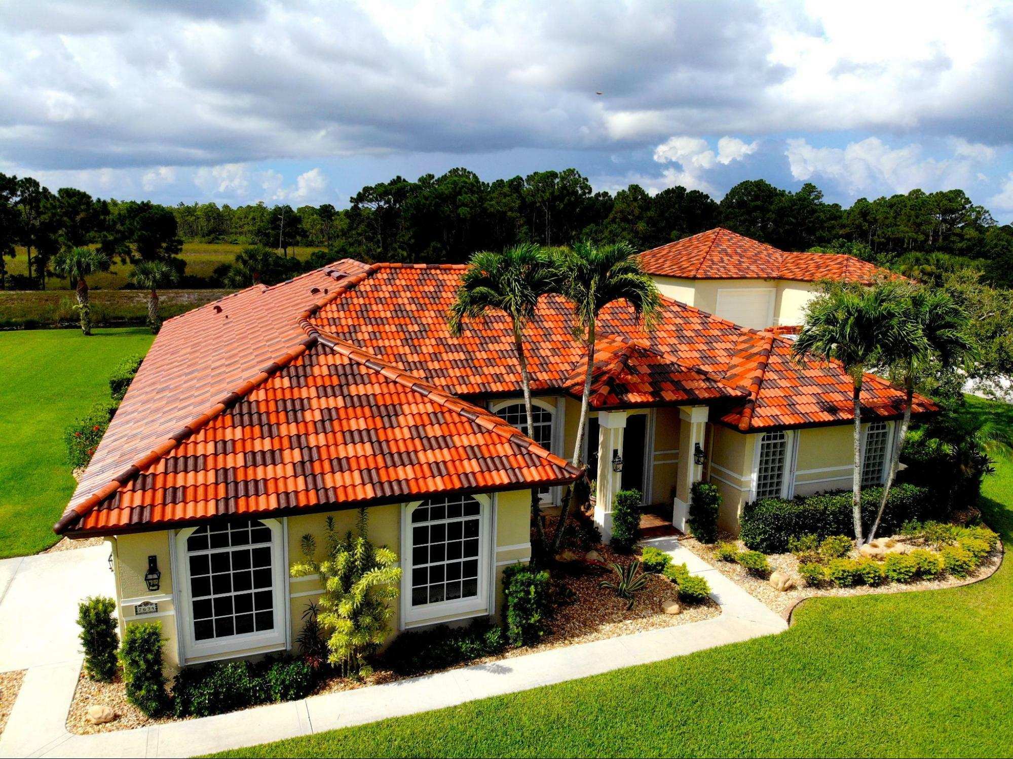 Orange barrel tile roof estate with palm trees