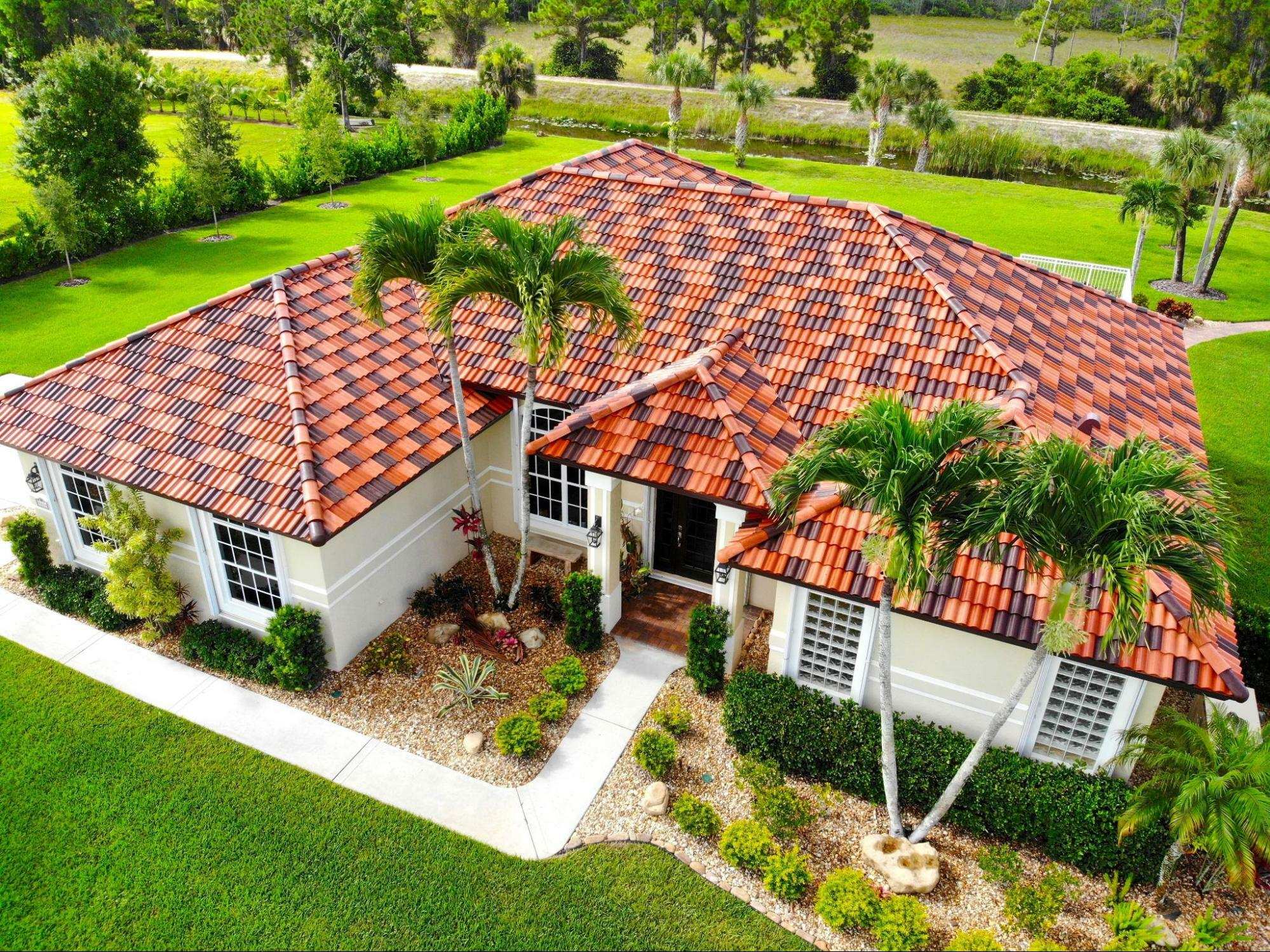 Orange barrel tile roof home front view with landscaping
