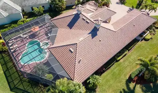 Tile roof home with screened pool enclosure