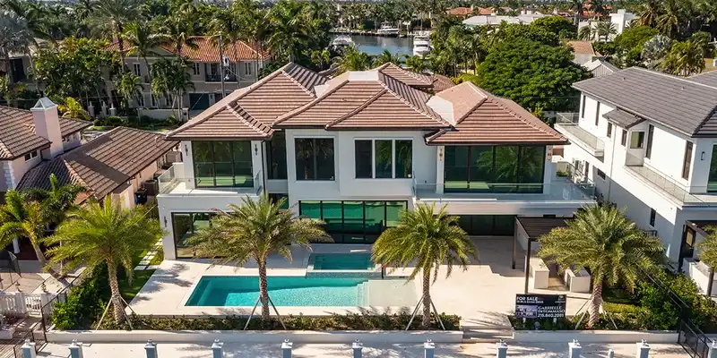 Waterfront luxury home with tile roof and pool